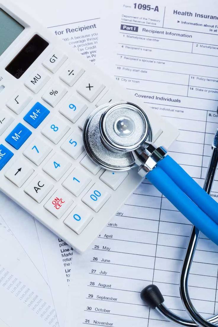 Hands reviewing insurance paperwork at a desk